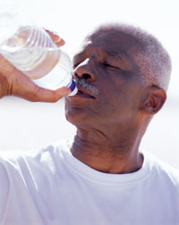 Photo: Man drinking bottled water